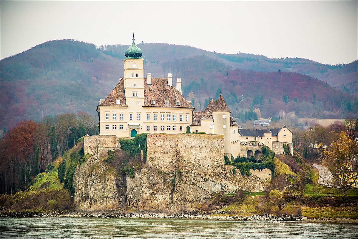European river cruise along the Danube past a hilltop castle