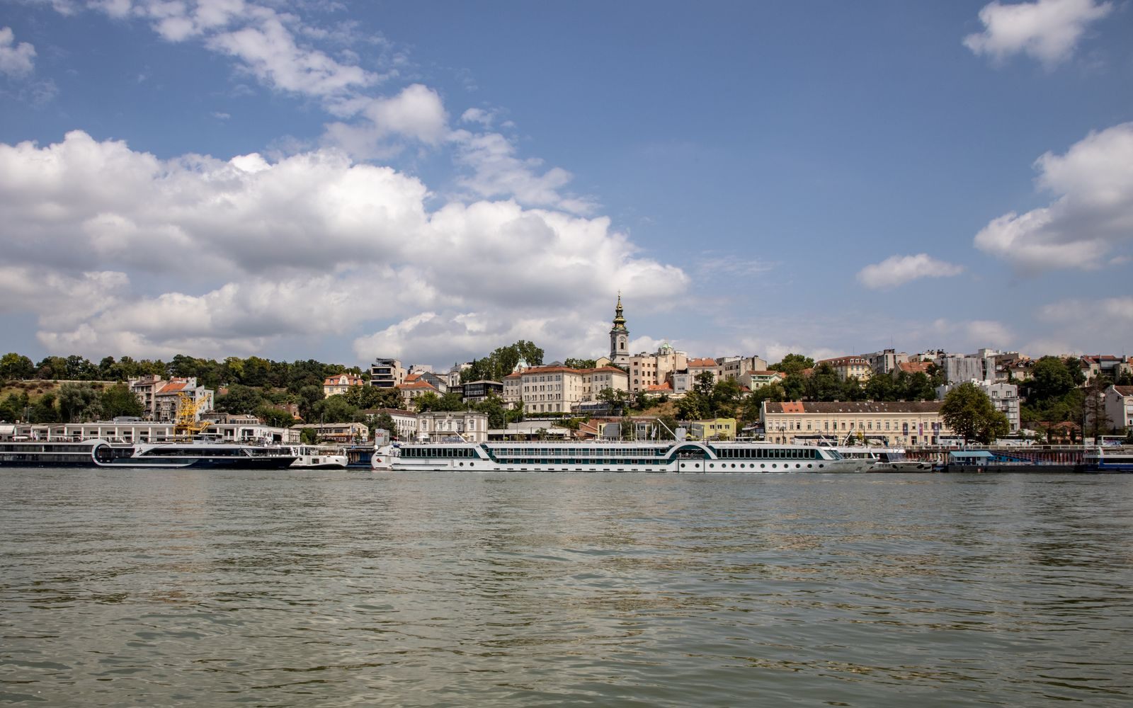 River cruise ships moored below the old town of Belgrade on the Sava